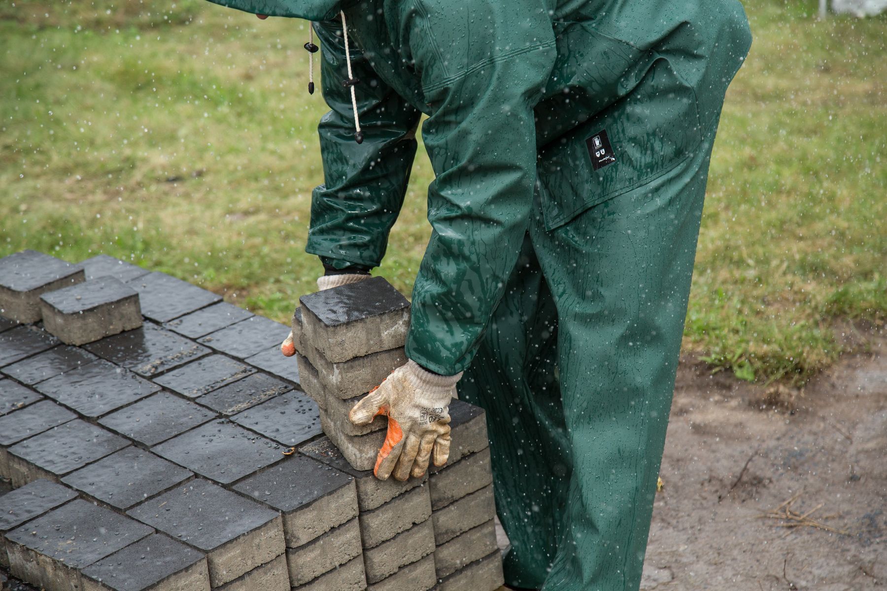Worker setting pavers for a walkway, shown as inspiration