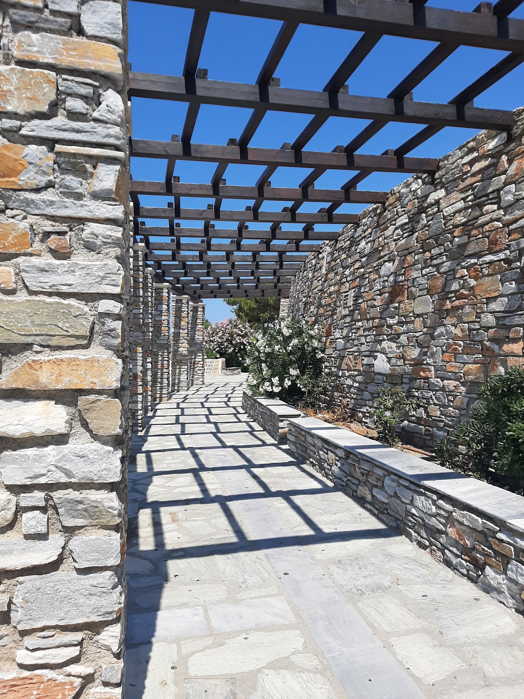 Paved stone walkway running between masonry walls